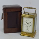 A late 19th century French brass repeating carriage clock with swing loop handle above rectangular
