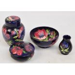 Four pieces of modern Moorcroft in the "Anemone" pattern on a rich blue ground, comprising a bowl,