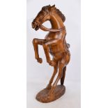 A large decorative carved oak figure of a rearing horse on oval base, height 100cm.
