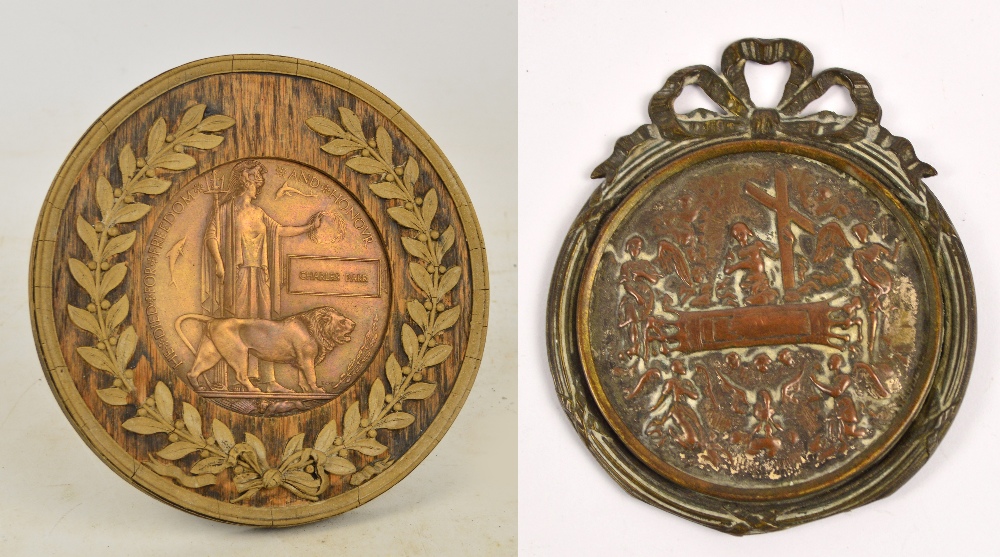 A WWI memorial plaque issued to Charles Parr, in circular wooden frame with wreath decoration,