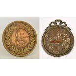 A WWI memorial plaque issued to Charles Parr, in circular wooden frame with wreath decoration,