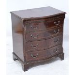 A serpentine mahogany chest of drawers of small proportions,