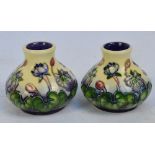 A pair of Moorcroft tube line decorated squat baluster vases in the "Hepatica" pattern,