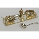 An Elizabeth II hallmarked silver three piece cruet set comprising mustard of oval form with shaped