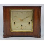 An Art Deco style walnut Elliot mantel clock with square section dial set with Arabic numerals and