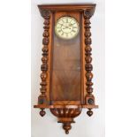 A late 19th century walnut twin weight Vienna wall clock,