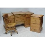 A modern pine desk with drawers and cupboards either side and a central raised section with hinged