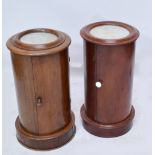 Two Victorian mahogany marble topped cylinder bedside cupboards raised on plinth bases,