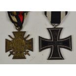 A German WWI Iron Cross with black and white ribbon and a further German 1914-18 Cross with red,