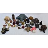 A large collection of various resin figures of tortoises in various sizes.