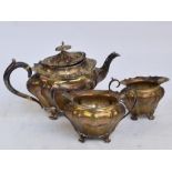 An Edwardian hallmarked silver three piece tea service of lobed form,