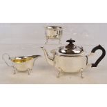 A George V hallmarked silver three piece tea set of oval form with pie crust rim,