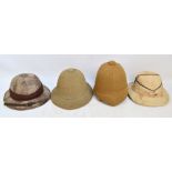 Four vintage pith helmets.