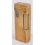 A Dunhill 9ct gold encased lighter with applied white metal initials "TG" in rectangular cartouche,