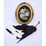 An Edwardian black parasol, the interior trimmed with cream lace edged black silk,
