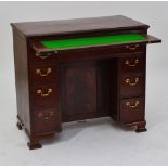 A late George III mahogany kneehole desk, the crossbanded top above brushing slide,