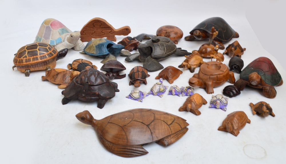 A collection of various carved wooden figures of tortoises, some acting as trinket boxes, ashtrays,