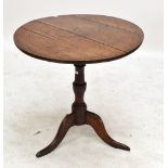 A Georgian oak circular tilt top tripod table on central turned column and cabriole legs,