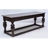 A 17th century and later oak refectory table, the three plank top with cleated ends,
