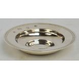 A small Elizabeth II hallmarked silver alms dish of plain circular form with line decorated rim and