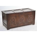 A large late 17th century oak coffer, the triple panelled top above carved panel front,