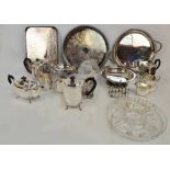 A collection of silver plated items including two tea sets, a cocktail shaker, trays, a toast rack,