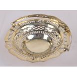 A George V hallmarked silver footed shaped circular basket with geometric pierced work to sides,