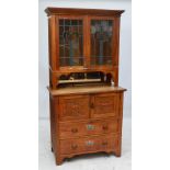 A Danish oak Arts and Crafts style dresser with twin clear and tinted glazed door and mirrored back
