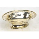 A George V hallmarked silver oval bonbon dish with pierced stylised floral motifs,