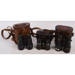Three pairs of leather cased field glasses, all WWI period.
