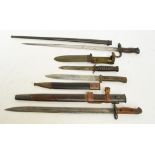A late 19th century French bayonet with tapering metal scabbard, two further bayonets,