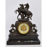 A late 19th century French black slate, marble and spelter mantel clock,