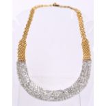 A contemporary 18ct yellow and white gold diamond encrusted bib necklace,