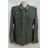 A period German Third Reich tunic with stitched badge above breast pocket.