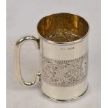 An Edward VII hallmarked silver christening mug with a central repoussé frieze decorated with