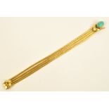 A textured four strand 18ct yellow gold bracelet with oval turquoise cabochon to the clasp,