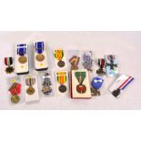 A collection of medals including a German Third Reich Mother's Cross, a German 1939 War Merit Cross,