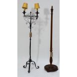 A wrought iron two branch standard lamp with wrythen stem on tripod scrolling base, height 146cm,