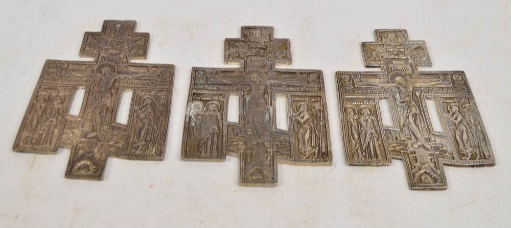 Three early 20th century Russian Orthodox white metal cast triple cross plaques depicting scenes of