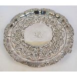 A George III hallmarked silver circular salver, with floral cast decorated raised rim,