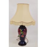 A modern Moorcroft lamp base of baluster form in the "Anemone" pattern on a rich blue ground,