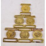 Six brass military belt buckles including The King's Regiment, The Duke of Wellington's Regiment,