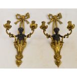 A pair of gilt metal and painted cherubic two branch wall sconces,