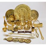 A quantity of brass items including candlesticks, chargers, chestnut roaster, horse brasses,