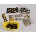 A large quantity of various military buttons, four belt clasps, and a button polishing tool.