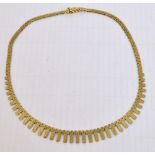 A 9ct yellow gold necklet, the textured brick chain suspending graduated hanging pieces,