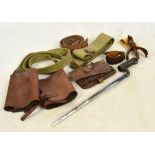 A group of military collectables including a spike bayonet, pair of spurs, canvas belt,