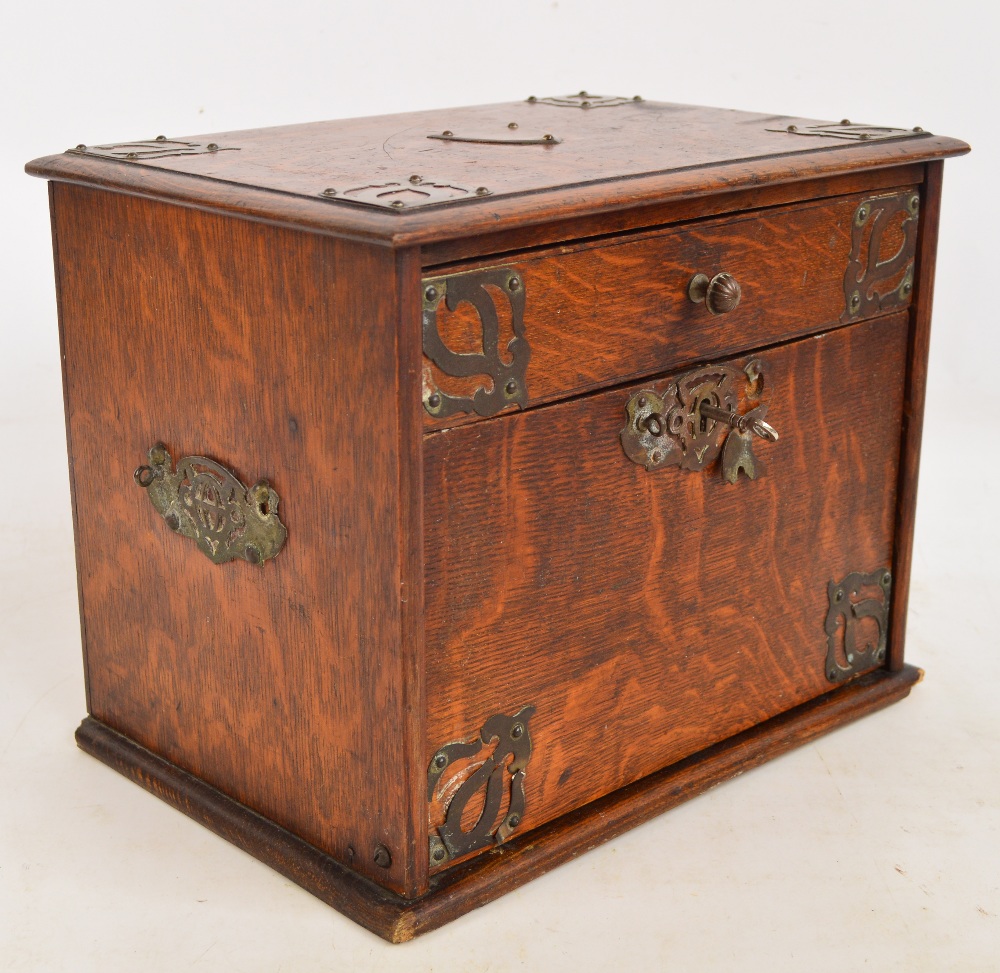 An Edwardian oak travelling box with single drawer above hinged drop down fall front with