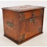 An Edwardian oak travelling box with single drawer above hinged drop down fall front with