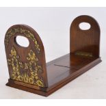 A mahogany adjustable book rack with hinged ends, with applied Art Nouveau style brass decoration,